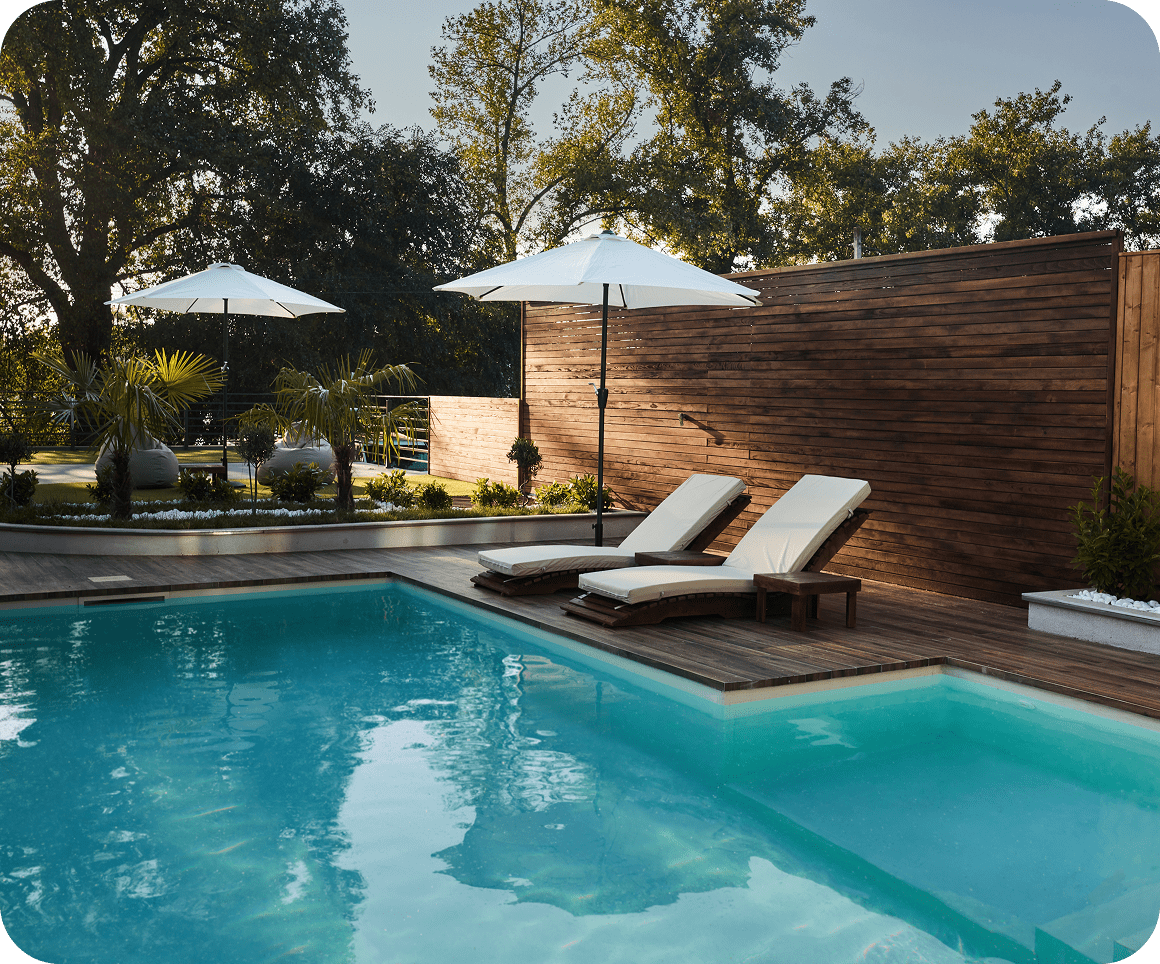 Poolside with loungers and umbrellas, sunny day.