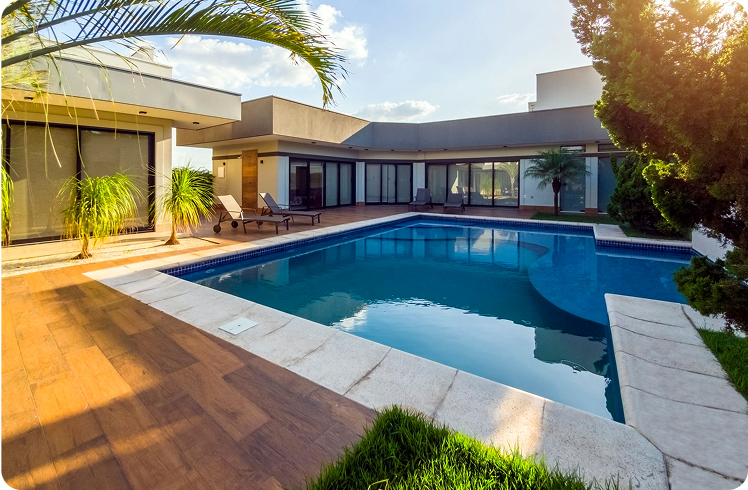 Modern house with outdoor swimming pool, sunny day.